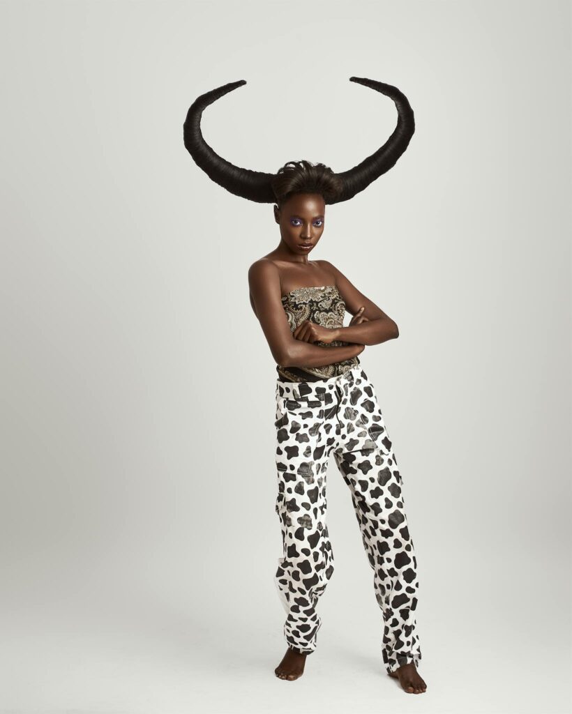 Striking portrait of a model with horned hairstyle in artistic fashion.